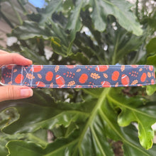 Navy blue dog collar with leaves, pumpkins and footballs throughout
